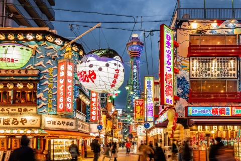 Street view of many lit up Japanese business signs
