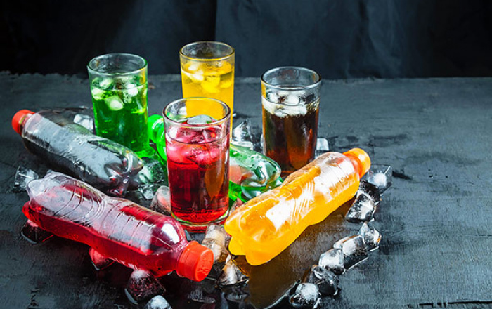 A variety of non-alcoholic beverages on a table surrounded by ice